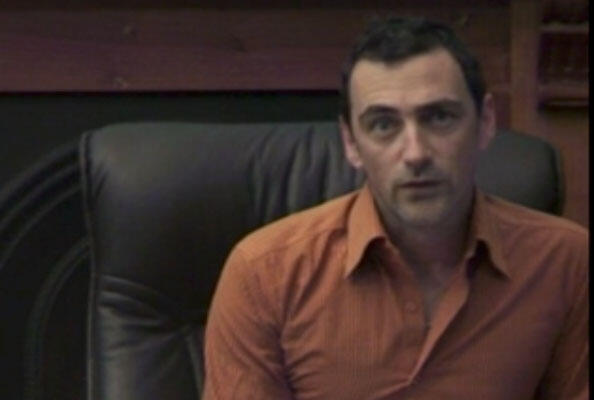 Still from video with man talking